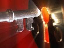 A grey key unlocking a shining lock.