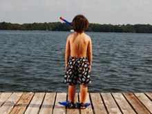 Boy with Arms by Sides on Dock