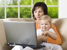 Mom and baby surf the internet on a laptop