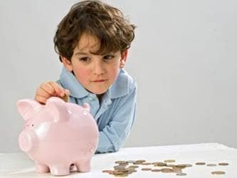 Talking to kids about the economy, boy with piggy bank