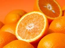 Bright Halved Oranges, on top of whole oranges