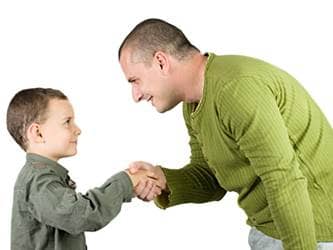 Be a role model of respect - dad teaches son to shake hands