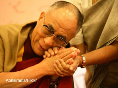 Dalai Lama holding hand