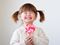 Little girl holding pink lollipop