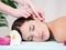 Woman having ear massaged