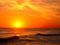 Orange sun setting on the ocean horizion