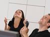 Man and woman thumbs up and excited at work