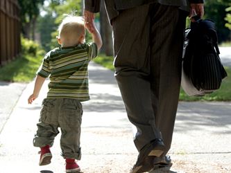 Dad and toddler holding hands