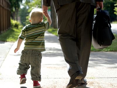 Dad and toddler holding hands
