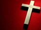 Wooden cross on red background
