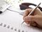 Hand writing in notebook with pen