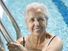 senior woman in a swimming pool, smiling