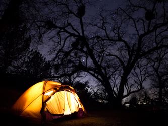 glowing camp tent at night