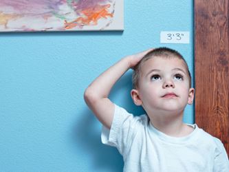teaching patience - boy measuring height