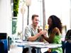 Man and woman sharing ice cream cones on a date