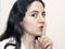 Black-haired woman requesting silence