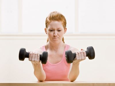 Woman lifting heavy weights