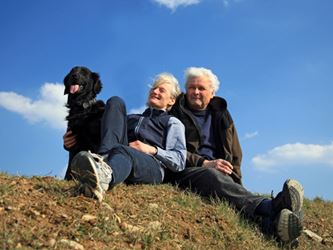 Elderly couple with a black dog