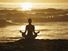 Silhouette of woman meditating on beach