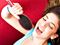 Girl singing into a brush