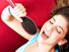 Girl singing into a brush