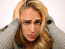 Woman holding head.