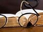 Glasses on top of a Bible