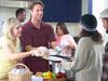 man and woman serving food