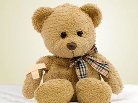 teddy bear with bandaid and tie