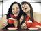 Girlfriends laughing over coffee