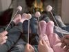 Family roasting marshmallows by the fireplace