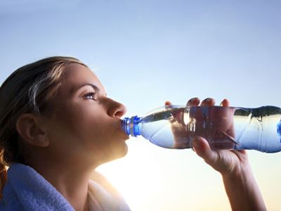 Athletic woman drinking water