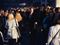 Man walking through large crowd of people