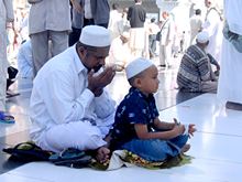 Muslim man and boy praying