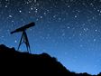 telescope against a starry night