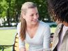women talking on park bench