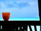 Red cup on a wall overlooking ocean