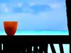 Red cup on a wall overlooking ocean