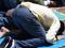 Muslim man in jeans praying