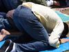 Muslim man in jeans praying