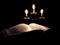Holy book with candles