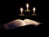 Holy book with candles