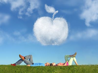 Couple in field and apple cloud