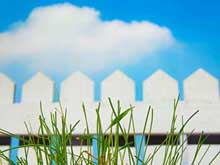 white picket fence on blue sky