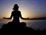 Woman Meditating During Sunset