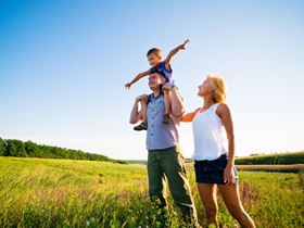 Healthy family walking in a field