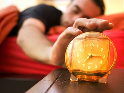 Man hitting the snooze button