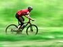 Bicycle going fast on green landscape