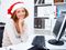 Santa hat woman in front of computer
