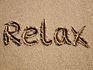Relax written in sand